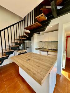 a kitchen with a wooden counter top in a room at Solleone 18 - Sea, Sun e Pool in Cavallino-Treporti