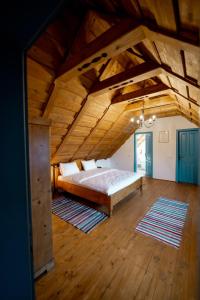 a large bedroom with a bed in a wooden ceiling at Azuria Viscri in Viscri +221 photos
