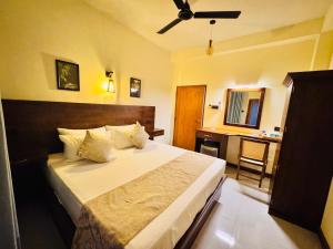 a bedroom with a bed with a ceiling fan at Novara Haven Airport Transit Hotel in Katunayaka +135 photos