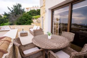 a wicker table and chairs on a patio at Beau Views Seven in Peyia