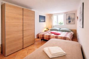 a bedroom with two beds and a large closet at Art house Tufi in Bistrica ob Sotli +28 photos