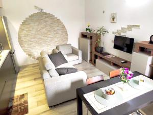a living room with a couch and a table at Casa Ramalma Estate in Brianza Appartamento tra Milano Monza e Como con self check-in in Seveso