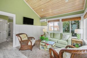 a living room with a couch and a tv at Inn at the Park Bed and Breakfast in South Haven