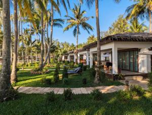 a house with palm trees in front of it at Mint Lotus Resort - Koh Kood in Ban Bang Bao