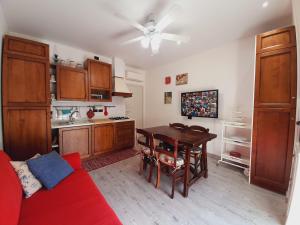 a kitchen with a red couch and a table in a room at B&B L'Incancellata in Corinaldo
