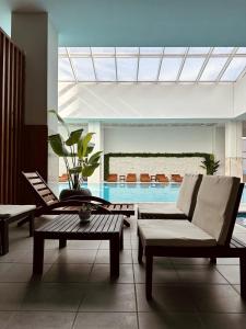 a living room with a couch and a swimming pool at Executive Sky Residence in Skopje