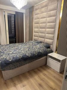a bedroom with a bed and a chandelier at Executive Sky Residence in Skopje +39 photos