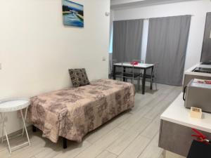 a hotel room with a bed and a table at Apartment Orio Volta in Orio al Serio
