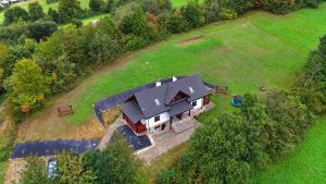 an overhead view of a large house in a field at Dom u Braci in Wołkowyja