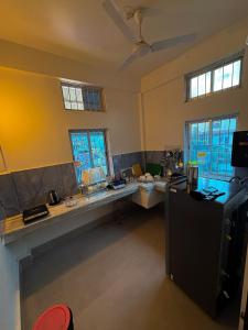 a large kitchen with a counter and a refrigerator at LN Homes in Itānagar