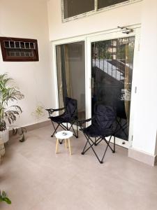 two chairs and a table on a patio at LN Homes in Itānagar