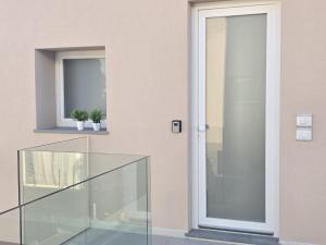 a glass door on a building with two potted plants at Salionze Apartments in Salionze +34 photos