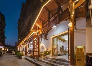 a store with lights on the side of a building at JINGJING·YUNXI·WEITANG HOTEL in Zhangjiajie