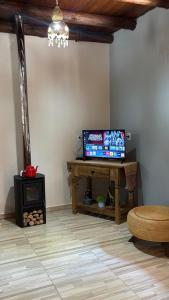 a living room with a table with a laptop on it at Pousada Canto dos Passáros in Timbe do Sul
