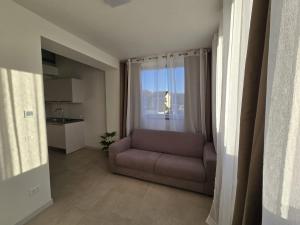 a living room with a couch and a window at Salionze Apartments in Salionze
