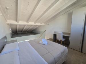 a bedroom with a white bed with a blue heart on it at Salionze Apartments in Salionze