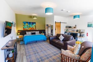 a living room with a bed and a couch at Modern Barn Conversion in Brackley +43 photos