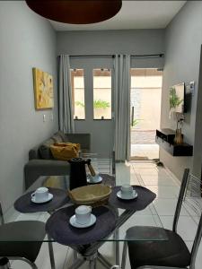 a living room with a table and chairs and a couch at Dunas residence casa 03 in Santo Amaro