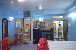 a man walking into a room with a bathroom at 3 Sixty House in Bodh Gaya