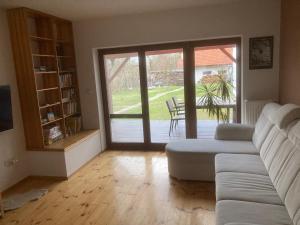 a living room with a couch and a sliding glass door at Ubytování pod Nadymákem in Telč