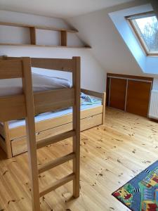 a bedroom with two bunk beds in a attic at Ubytování pod Nadymákem in Telč
