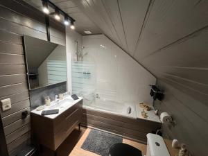 a bathroom with a sink and a bath tub at Gîte Libre’Air in Redu +19 photos