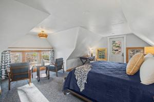 a bedroom with a bed and a table and chairs at Waters View Inn in South Haven