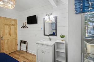 a bathroom with a sink and a mirror at Waters View Inn in South Haven +125 photos