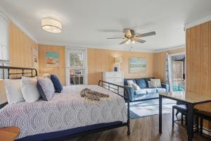 a bedroom with a bed and a living room at Waters View Inn in South Haven