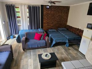 a living room with a couch and a chair at The Pot in Pretoria