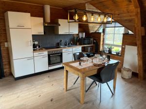 a kitchen with a wooden table and a dining room at Gîte Libre’Air in Redu