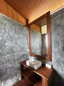 a bathroom with a sink and a mirror at Panoramic Samplik View Sidemen in Silebeng