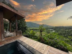 a house with a plunge pool and a view of the mountains at Panoramic Samplik View Sidemen in Silebeng