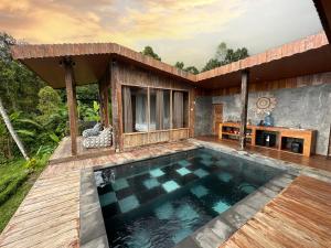 a house with a swimming pool on a deck at Panoramic Samplik View Sidemen in Silebeng +5 photos
