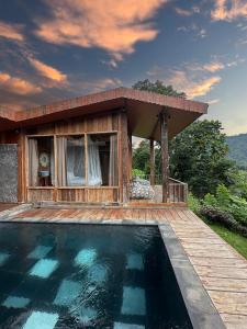 a swimming pool in front of a house at Panoramic Samplik View Sidemen in Silebeng