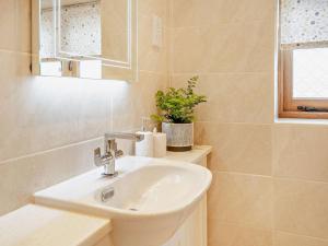 a bathroom with a sink and a mirror at 1 Bed in Chepstow oc-91941 in Chepstow +34 photos