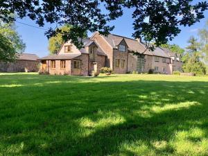 a large grassy yard with a large house at 1 Bed in Chepstow oc-91941 in Chepstow