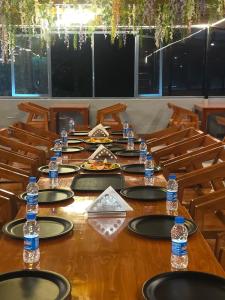 a long table with chairs and bottles of water on it at Pi Palace in Bhīm Tāl