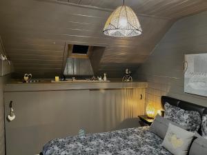 a bedroom with a bed and a counter with a sink at Gîte Libre’Air in Redu