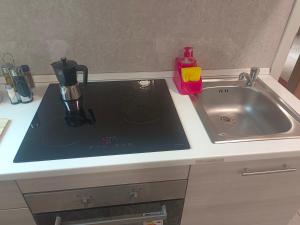 a kitchen sink with a coffee maker on top of it at appartamento di venezia in Venice +49 photos