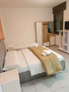 a bedroom with two beds and a television in it at appartamento di venezia in Venice