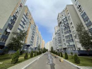 an empty street in a city with tall buildings at Buicani Confort Stay in Chişinău