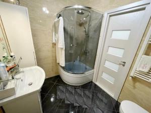 a bathroom with a shower and a toilet and a sink at Buicani Confort Stay in Chişinău