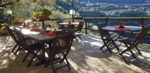 a wooden table and chairs on a patio with a view at Agriturismo I Pipetta in Levanto