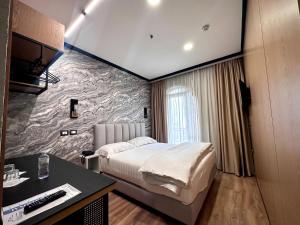 a hotel room with a bed and a desk at PANORAMA Rooms Hotel near the Old Bazaar in Krujë