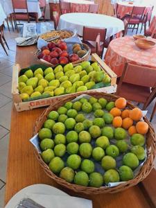 a table with baskets of fruit on top of it at Hotel Cristallo Cesenatico in Cesenatico +11 photos
