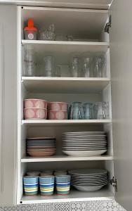 a cabinet filled with plates and bowls and dishes at Villa Porotupa in Syöte +28 photos