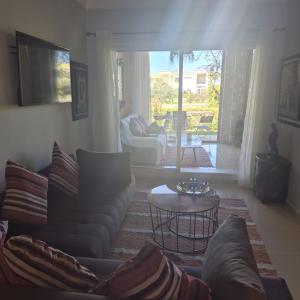a living room with a couch and a table at Résidence du golf in Fez