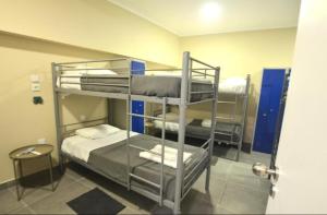 a room with three bunk beds in a room at Stay DP Setúbal in Setúbal