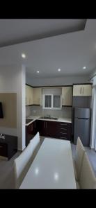 a living room with a white couch and a kitchen at Luxury Room's by Lika in Sarandë +43 photos